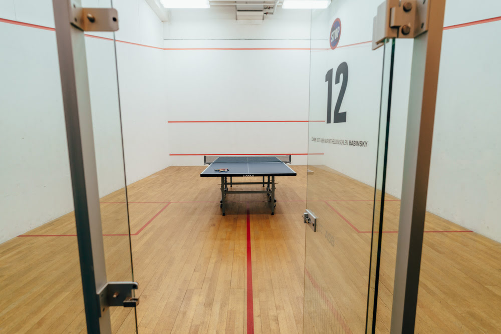 Tischtennis-Platte in blau  im Tischtennis-Court des Sportcentrum Nürnberg, mit der Nummer 12 auf der offenen Glastür